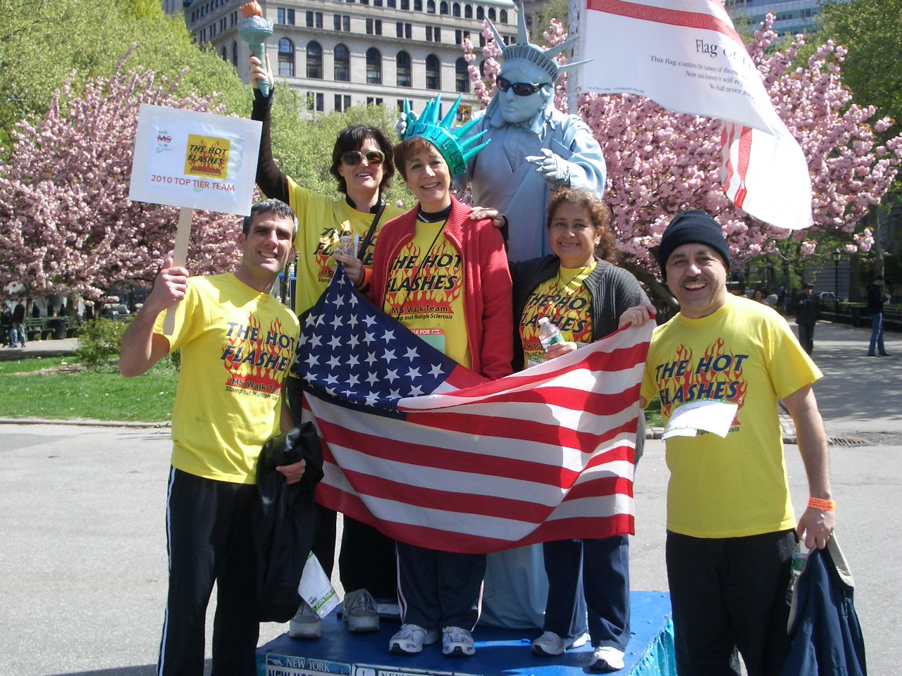 Picture of the Hot Flashes team at South Street Seaport in 2010, with Lady Liberty